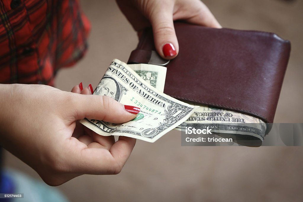 Paying Woman with one dollar bill Gratuity Stock Photo