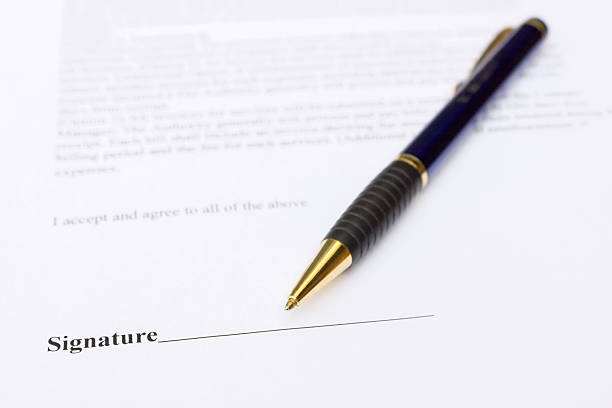 istock Pen for signature lying on contract paper 512174469