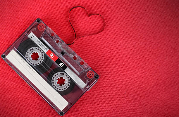 istock Vintage audio cassette with loose tape shaping a heart 512174559