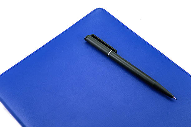 istock Leather notebook and pen isolated on the white 512174731