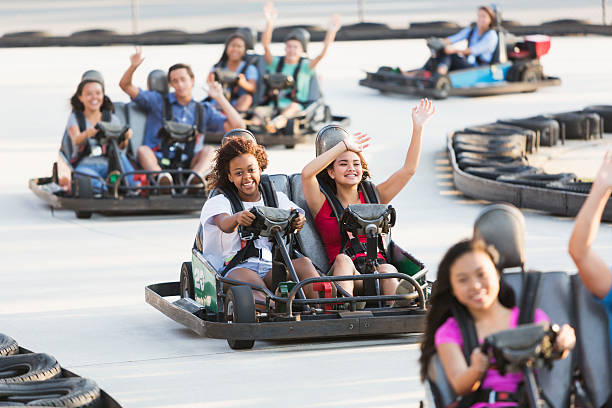 istock Group of teens riding go carts 512174831