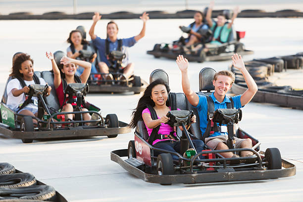 istock Group of teens riding go carts 512174851