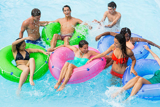 istock Teenage friends floating on innertubes 512174865