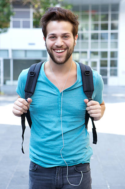 istock Happy young man walking outdoors with bag 512176275
