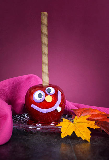 istock Happy Halloween  smiling crazy face red toffee apple candy 512176445