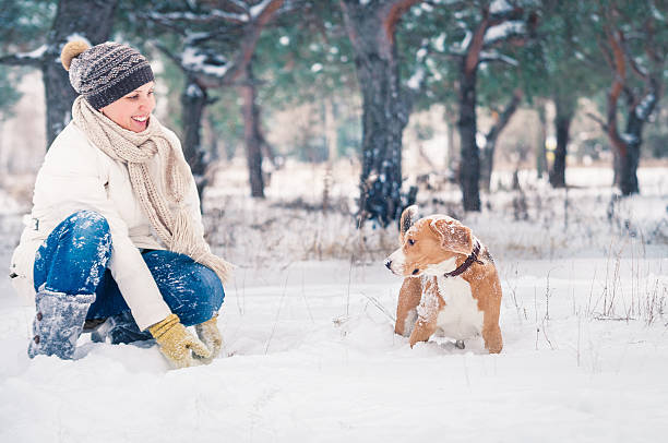 istock Woman playing with her pet in snow 512176973