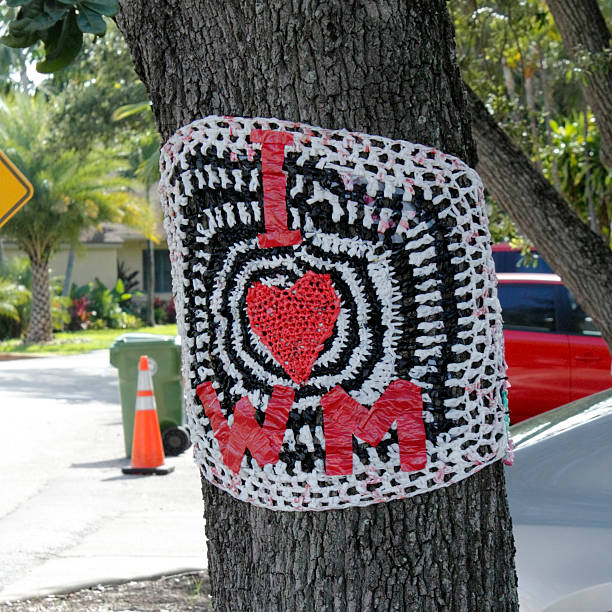 Wilton Manors, Florida, USA - June 22, 2013: A red white and black plastic and tape sign tied to a tree along Wilton Drive showing the letters I, a heart and initials WM, standing for I Love Wilton Manors.