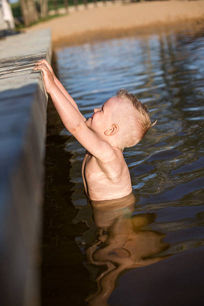 istock Happy kid trying to climb on the footbridge 512184241