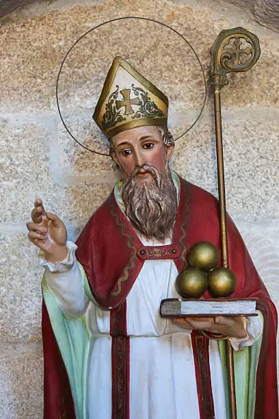 Statue of Saint Nicholas of Bari in the church of San Francisco in the historic town Betanzos, Galicia, Spain. Saint Nicholas is holding three balls of gold, that represent the legend of the dowry he gave to three unmarried girls. This statue was created more than 200 years ago, no property release is required.