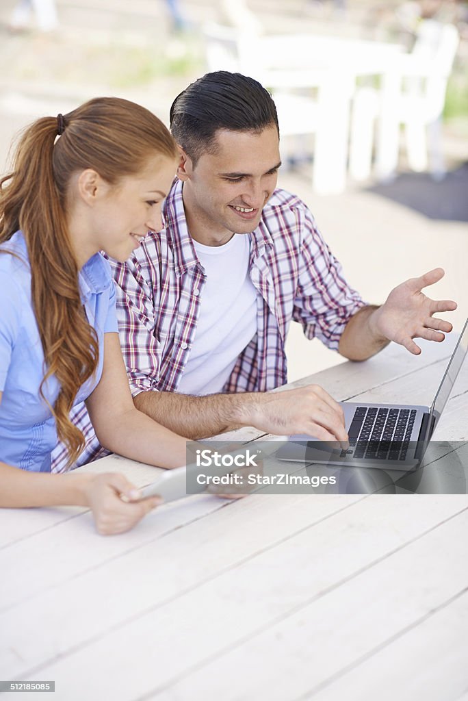 Helping her start a business Shot of a young man and woman using a digital tablet and laptophttp://www.azarubaika.com/iStockphoto/2014_05_31_Remote_Workers.jpg 20-29 Years Stock Photo