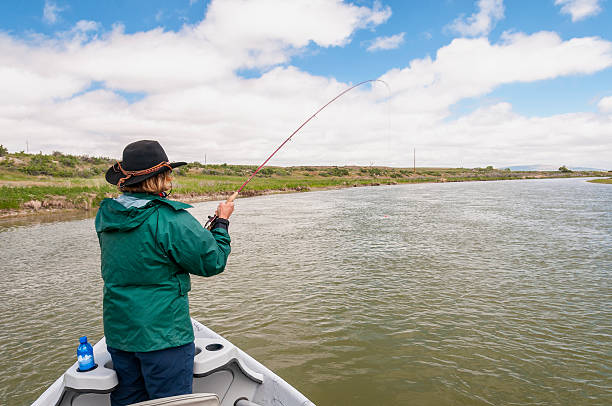 istock Woman Fly-Fishing from Drift Boat 512186027