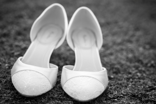 Bride's wedding shoes, toned black and white image.