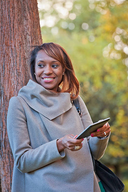 istock Businesswoman Using Mobile Phone in Park, London UK 512189391