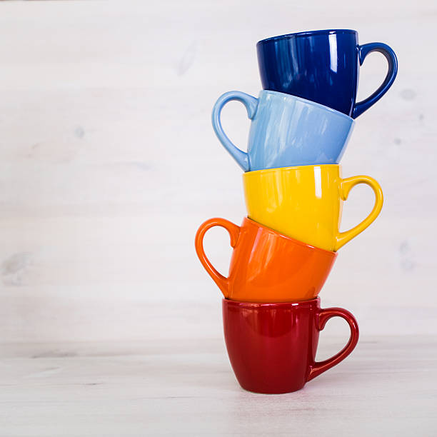 istock stack of colorful coffee cups on a white wooden background 512200382