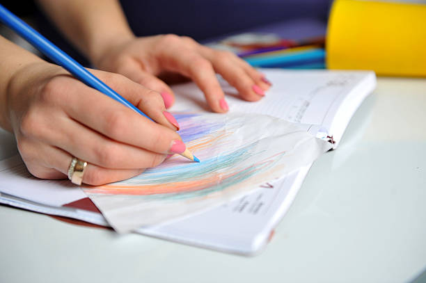 istock Close-up of hand pen writes in a notebook 512201490