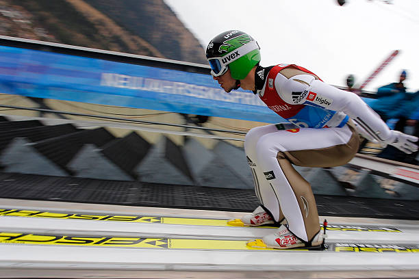 Young boy skiing and taking a big jump on a sunny day in the ski resort St .Anton am Arlberg, Austria