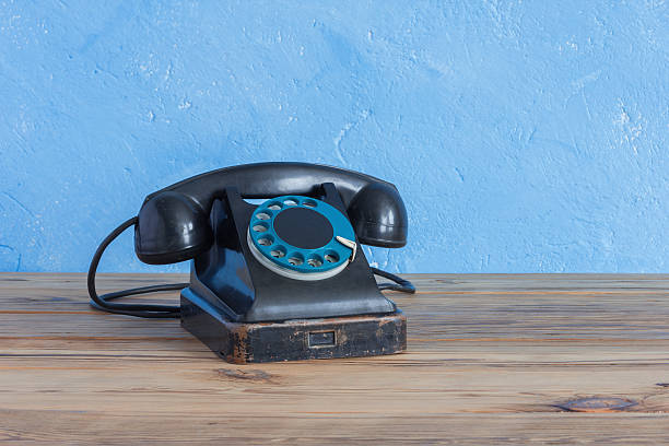 istock Vintage phone on a wooden table 512204426