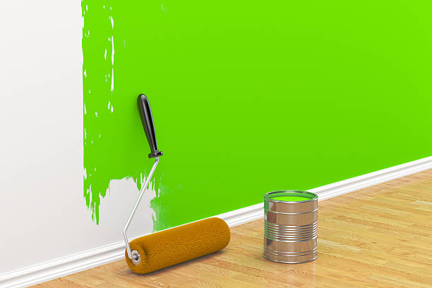 istock concept on repair: roller brush painting the white wall 512207294