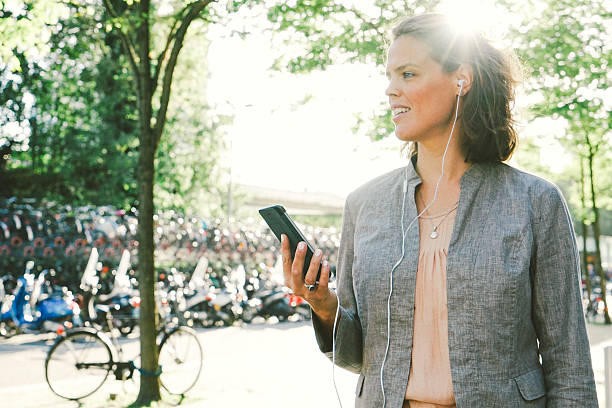 Portrait Of Successful Businesswoman Using Smartphone In Urban Landscape Portrait of successful businesswoman using smartphone in urban landscape. cityscape videos stock pictures, royalty-free photos & images