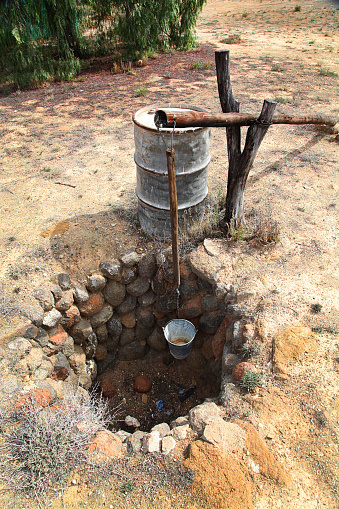 Old traditional way of getting water. Dry well in Africa.