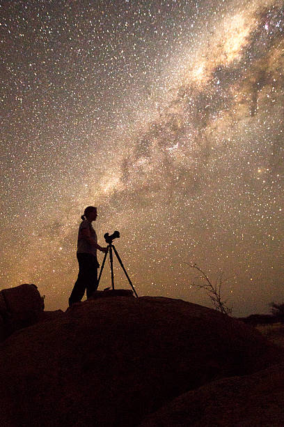 Photographer under the milky way Photographer under the milky way astrophotography stock pictures, royalty-free photos & images