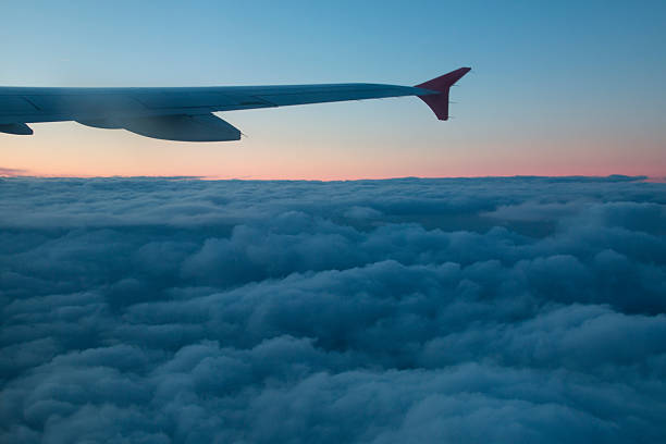istock Wing of an airplane with dark clouds below 512209290