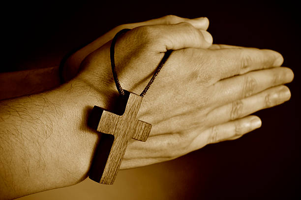 istock young man praying, sepia toning 512209686
