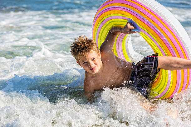 istock Adolescent Boy Enjoys the Surf 512210741