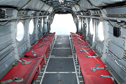 The grey interior and red troop seats of a Chinook Helicopter
