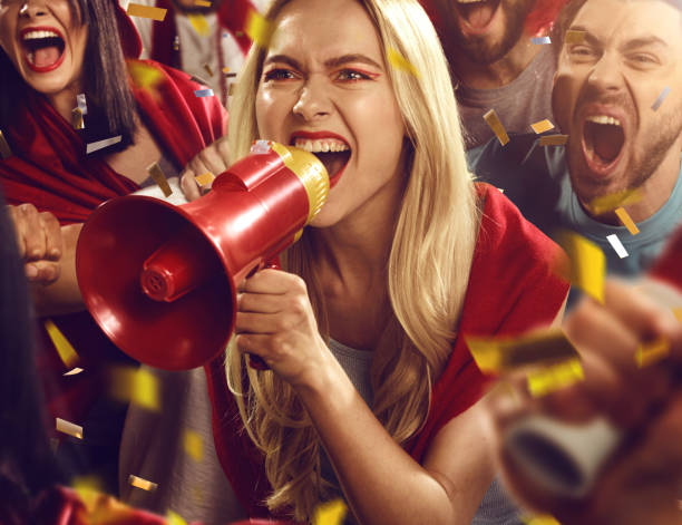 istock Sport fans: Girl is shouting in megaphone 512211270