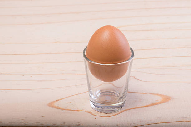 istock Eggs on the glass on the wooden floor 512211275
