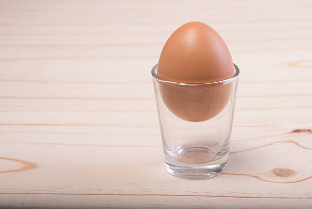 istock Eggs on the glass on the wooden floor 512211975