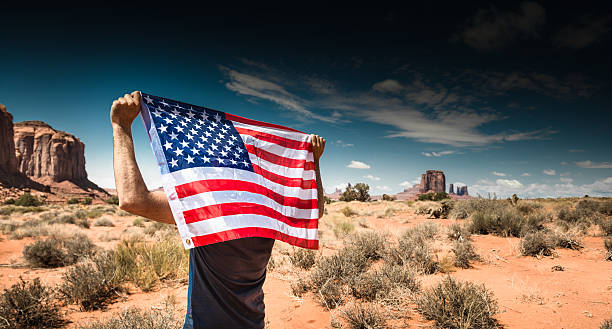 istock Tourist with flag on Monument valley National park 512212840