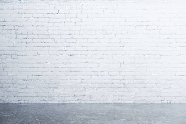 istock White brick wall and concrete floor in empty room 512213856