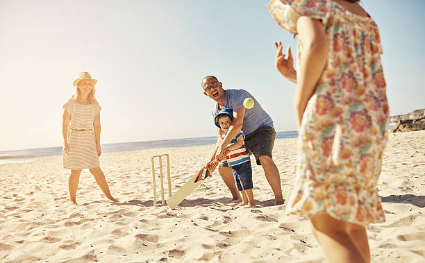 Plan a fun day at the beach Shot of a happy family playing cricket on the beachhttp://195.154.178.81/DATA/i_collage/pu/shoots/806441.jpg lens flare offspring daughter human age stock pictures, royalty-free photos & images