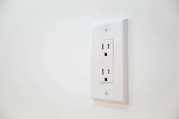 Photo of White Electrical Outlet and Wall Plate