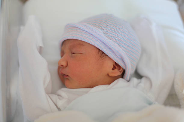 istock Newborn sleeping in the hospital crib. 512217641