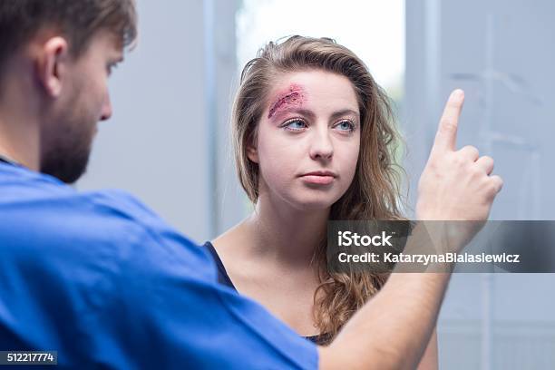 Doctor Diagnosing Injured Woman Stock Photo - Download Image Now - Physical Injury, Eye, Human Nervous System