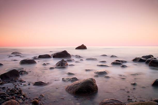 istock Sunset at rocky coast of sea. Low shutter speed 512219904