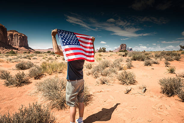 istock Tourist with flag on Monument valley National park 512220122