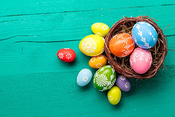 istock Easter eggs in basket placed on wooden planks 512220260
