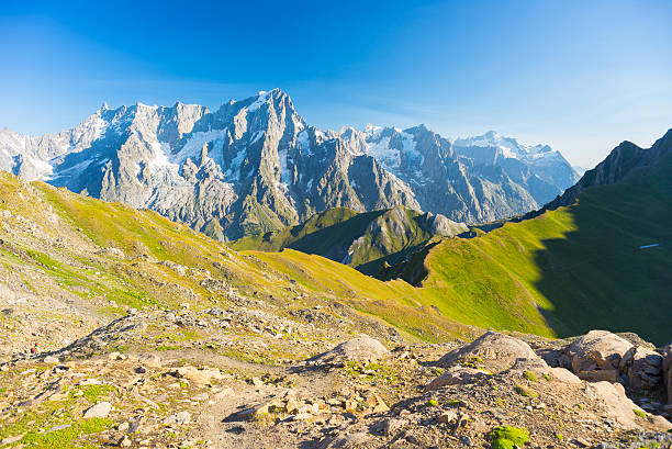 Majestic Mont Blanc massif and lush green alpine valley Hih mountain trail with great panoramic view over the Mont Blanc massif. Backpacker's summer adventures and wanderlust in Valle d'Aosta, Italian French Alps. mont blanc photos stock pictures, royalty-free photos & images
