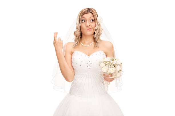 istock Young bride with her fingers crossed 512221804