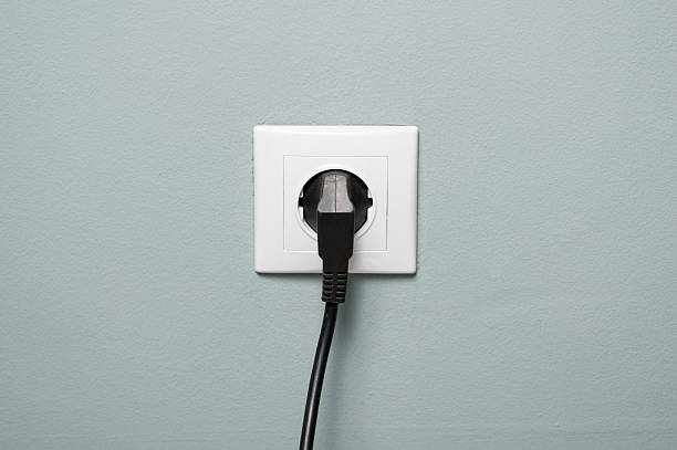istock Closeup of electric socket with black cable plugged in 512222302