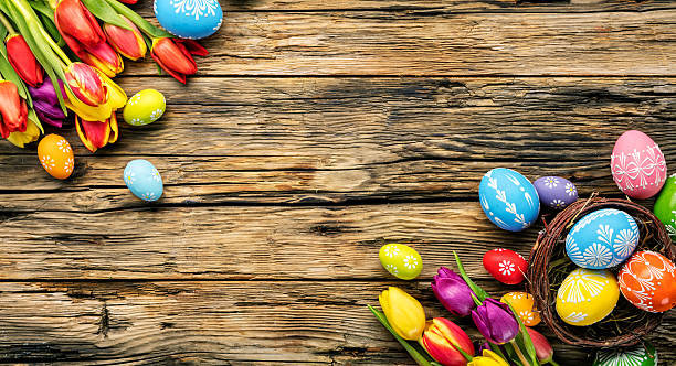 istock Easter eggs and tulips on wooden planks 512223130