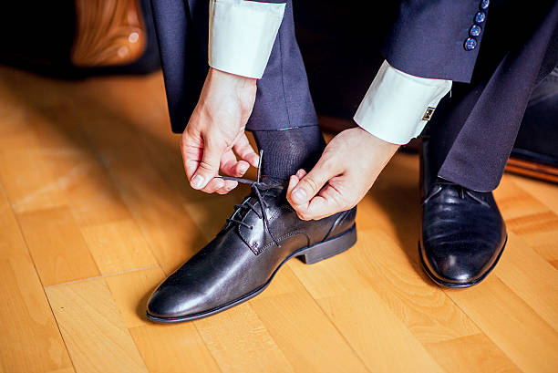 istock man who ties his black shoes 512223236