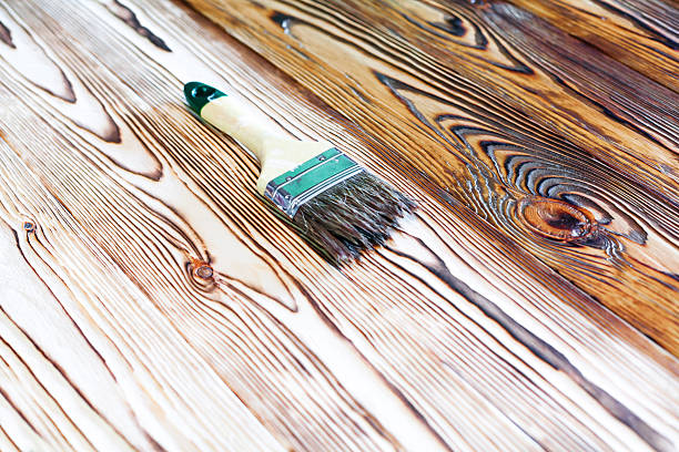 istock Painting natural wood with paint brush 512223962