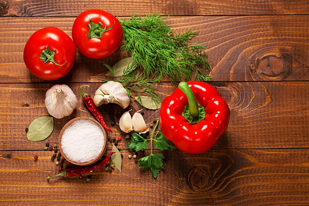 Pepper and tomatoes with garlic on a vintage wooden table stock photo