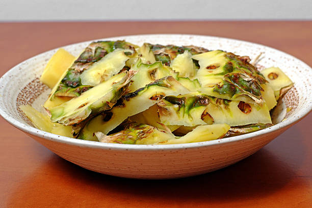 Bio waste pineapple in a ceramic bowl on wooden table