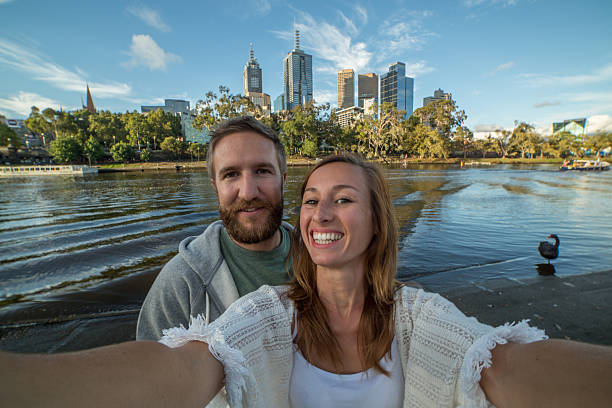 Cheerful young couple in Melbourne take a selfie portrait
